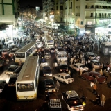 A traffic street scene at night in downtown Cairo